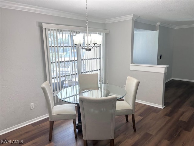 dining space featuring dark hardwood / wood-style floors, an inviting chandelier, and ornamental molding