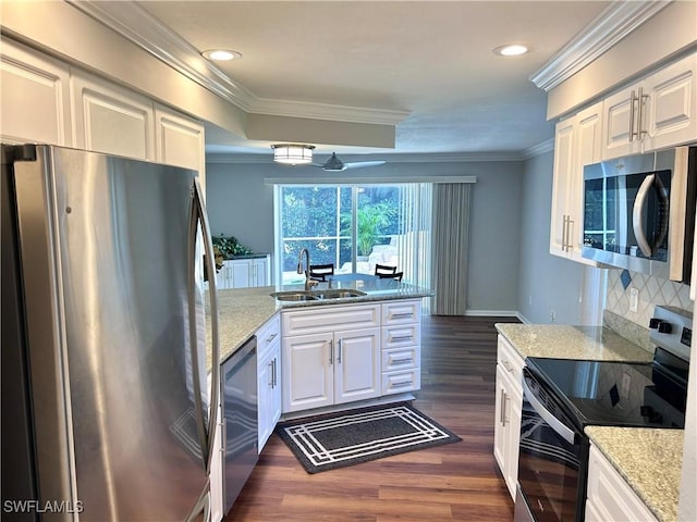 kitchen with white cabinets, sink, dark hardwood / wood-style floors, light stone countertops, and stainless steel appliances