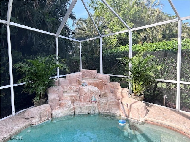 view of swimming pool with a lanai