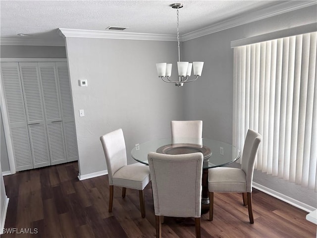 dining area featuring an inviting chandelier, dark hardwood / wood-style floors, plenty of natural light, a textured ceiling, and ornamental molding