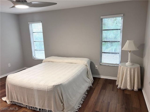 bedroom with ceiling fan and dark hardwood / wood-style flooring