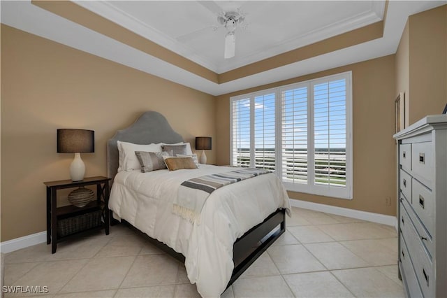 tiled bedroom with ceiling fan, ornamental molding, and a raised ceiling