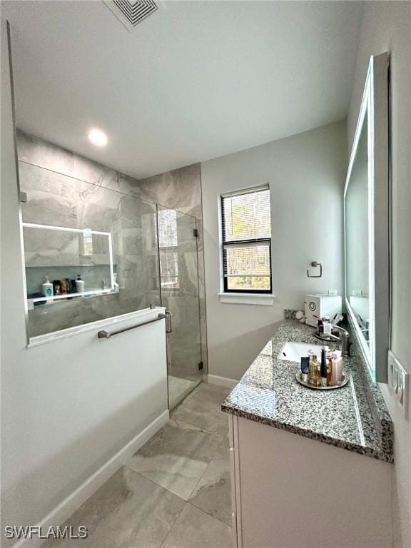 bathroom with vanity and walk in shower