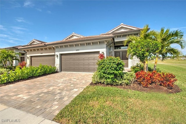 view of front of home with a garage and a front lawn