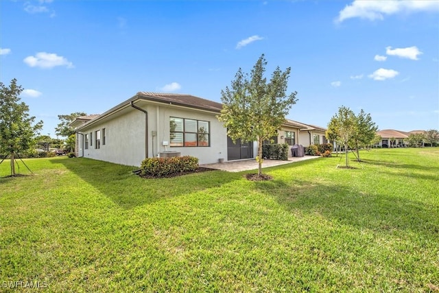 rear view of house with a patio area and a lawn