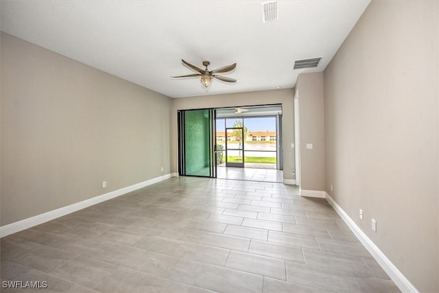 tiled empty room featuring ceiling fan