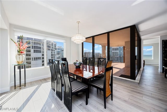 dining area featuring light hardwood / wood-style flooring and a chandelier