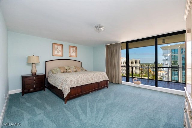 carpeted bedroom featuring access to exterior and a wall of windows