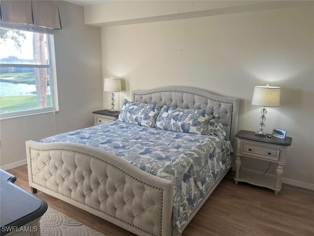 bedroom with dark wood-type flooring