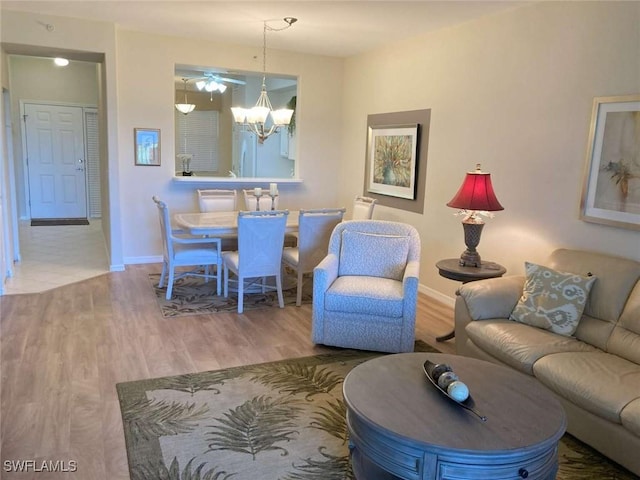 living room with hardwood / wood-style floors and an inviting chandelier