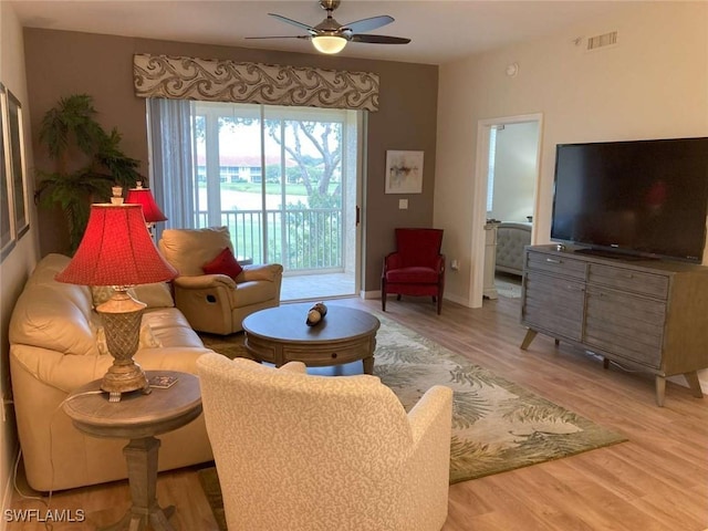 living room with hardwood / wood-style flooring and ceiling fan