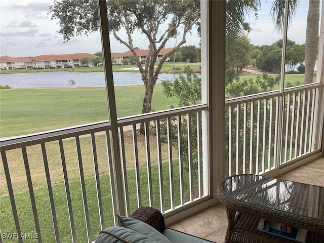 sunroom with a water view and a healthy amount of sunlight