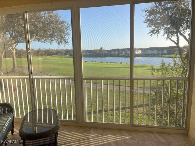 unfurnished sunroom with a wealth of natural light and a water view