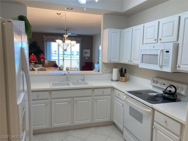 kitchen featuring sink, white cabinets, a notable chandelier, white appliances, and light tile patterned floors