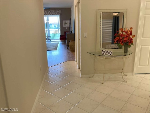 hall featuring light tile patterned flooring