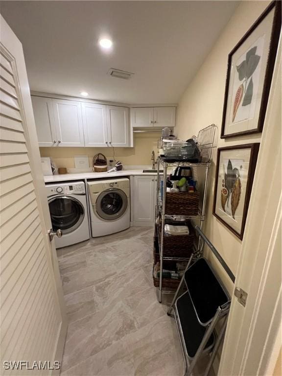 laundry room featuring washing machine and dryer and sink