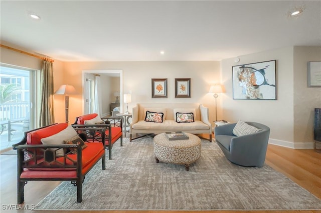 living area with recessed lighting, wood finished floors, and baseboards