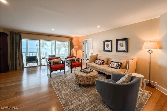 living room with recessed lighting, baseboards, and wood finished floors