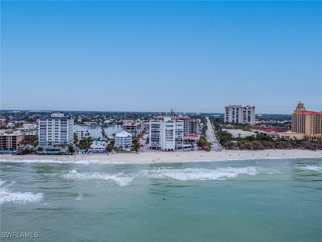 birds eye view of property with a city view, a view of the beach, and a water view