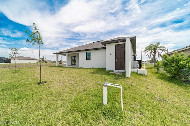 back of house with a lawn