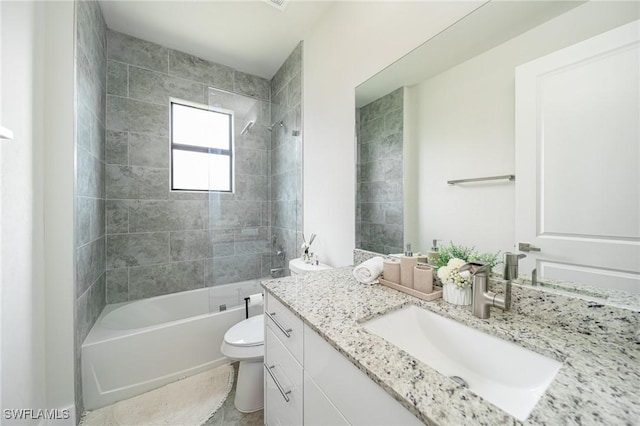 full bathroom featuring toilet, vanity, and tiled shower / bath