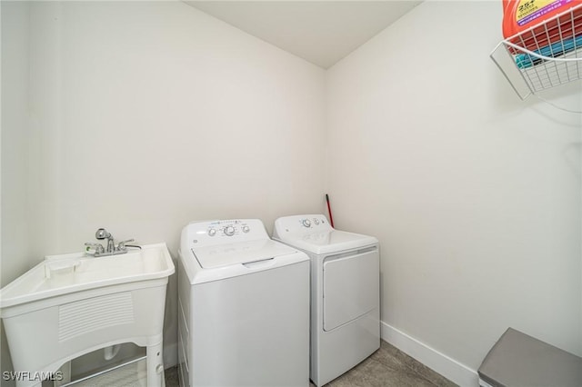 washroom with sink and washer and dryer