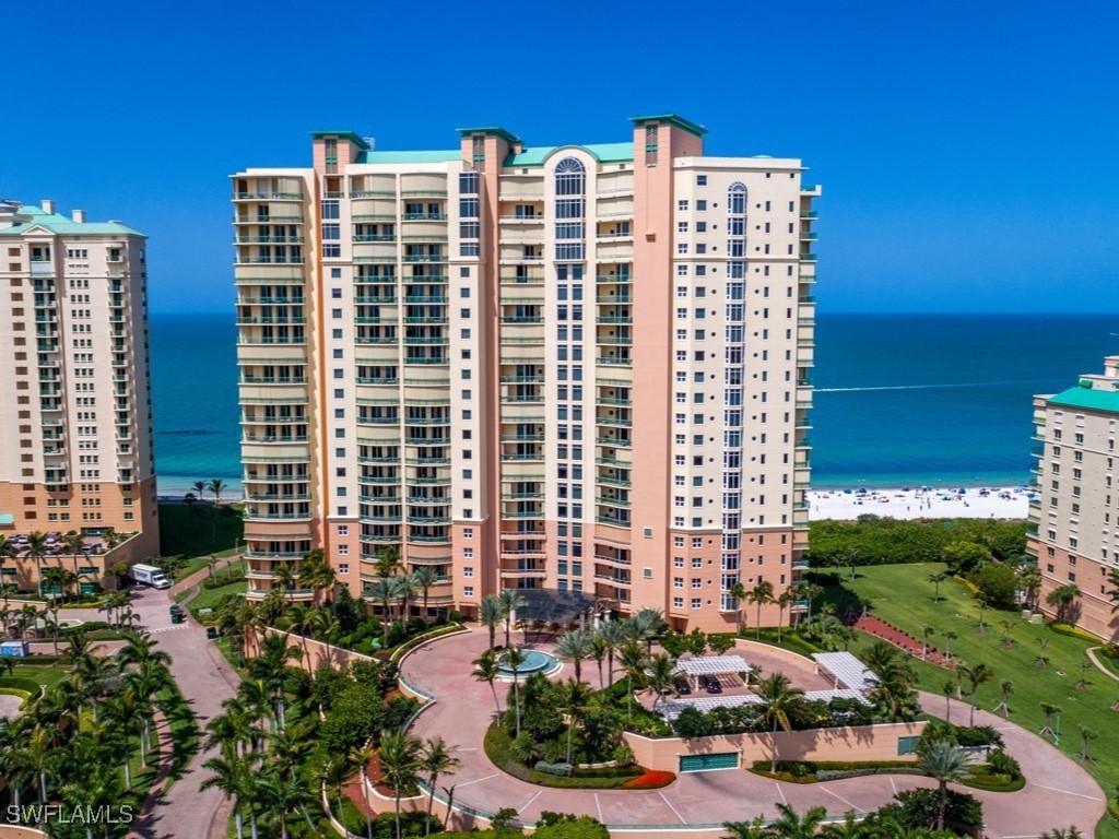 view of property with a beach view and a water view