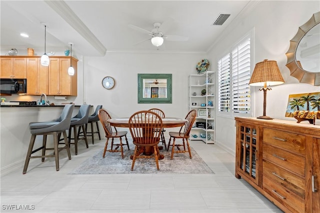 dining room with crown molding and ceiling fan