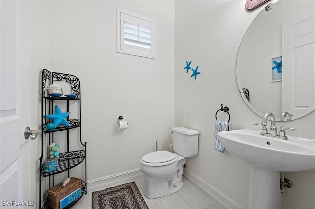 bathroom with tile patterned floors, toilet, and sink