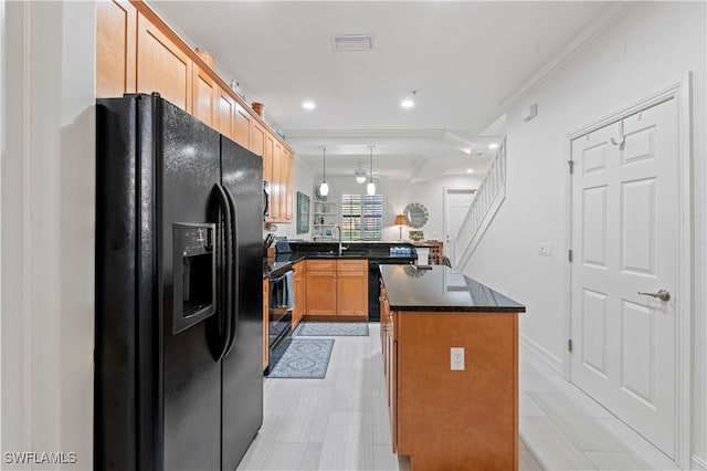 kitchen with kitchen peninsula, crown molding, black appliances, a kitchen island, and hanging light fixtures