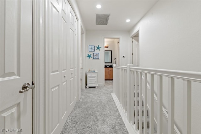 hallway with light colored carpet