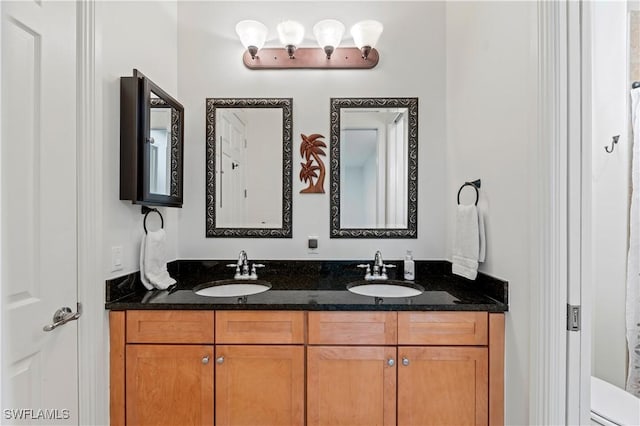 bathroom featuring vanity and toilet