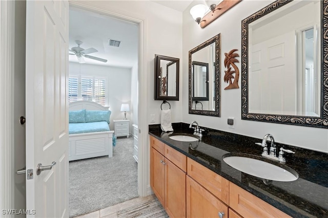 bathroom with ceiling fan, tile patterned flooring, and vanity