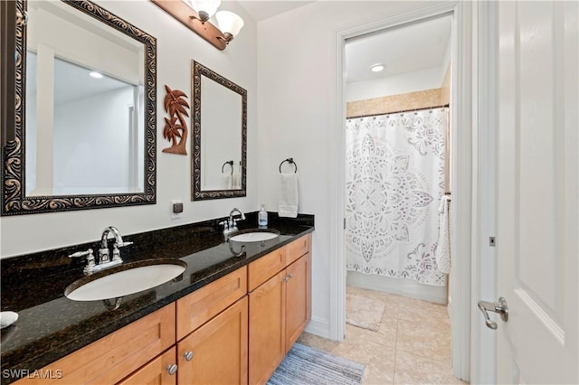 bathroom with tile patterned flooring, vanity, and shower / bath combo