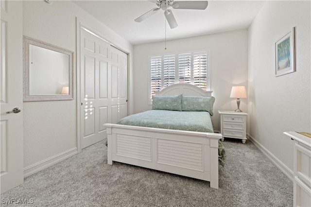 carpeted bedroom featuring a closet and ceiling fan