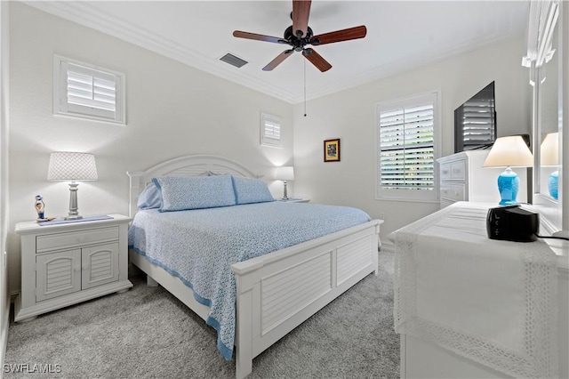 bedroom featuring light carpet, ceiling fan, and crown molding