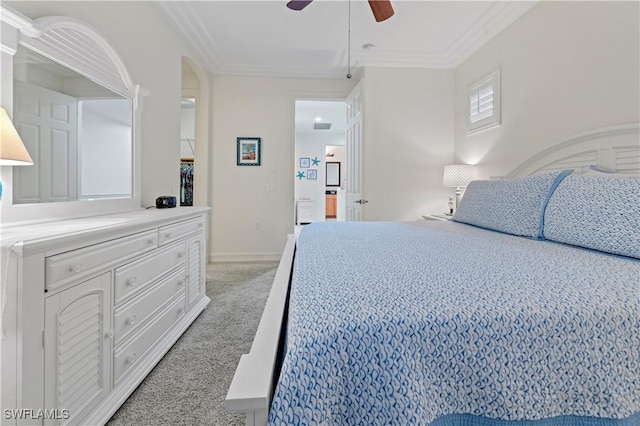 carpeted bedroom featuring ceiling fan and crown molding