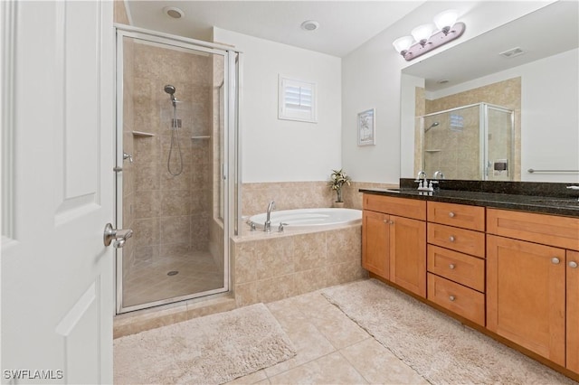 bathroom featuring vanity, separate shower and tub, and tile patterned floors