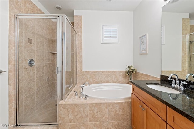 bathroom featuring plus walk in shower and vanity