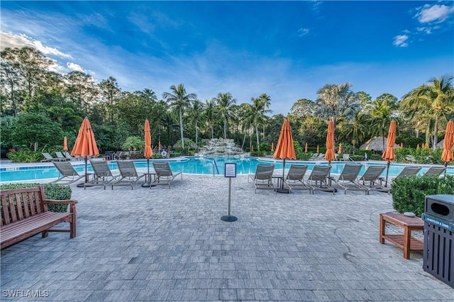 view of pool featuring pool water feature and a patio