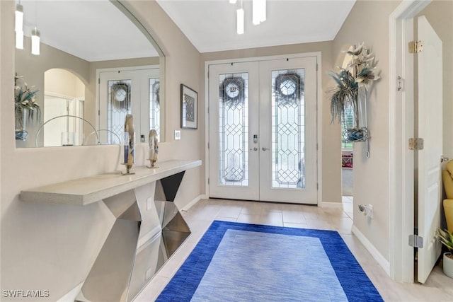 entrance foyer featuring light tile patterned floors and french doors