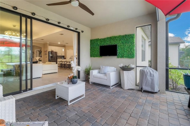 sunroom / solarium featuring ceiling fan