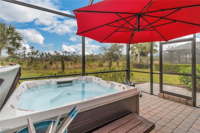 exterior space featuring a patio area and a hot tub