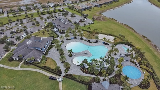 birds eye view of property with a water view