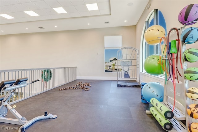 workout area featuring a paneled ceiling