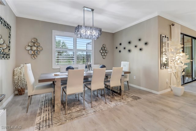 dining space featuring light hardwood / wood-style floors, ornamental molding, and a notable chandelier