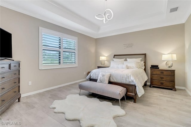 bedroom with a raised ceiling and a notable chandelier