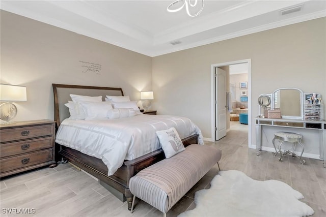 bedroom featuring a tray ceiling and crown molding