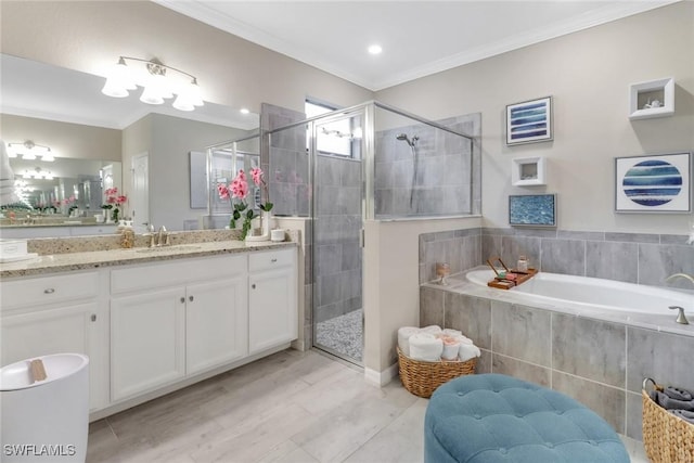 bathroom with vanity, independent shower and bath, and ornamental molding