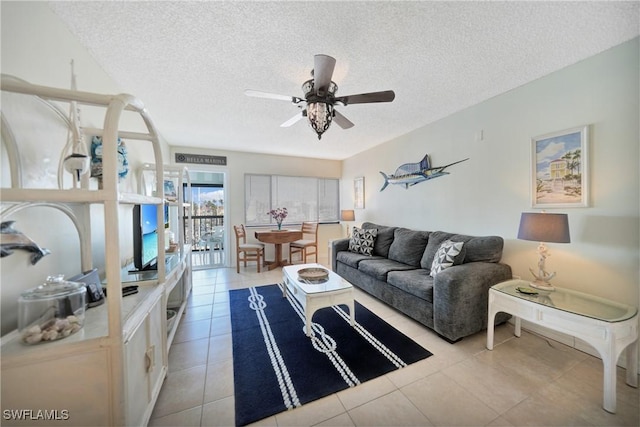 tiled living room featuring ceiling fan and a textured ceiling